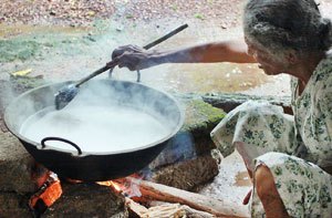 photo of woman making traditional coconut oil