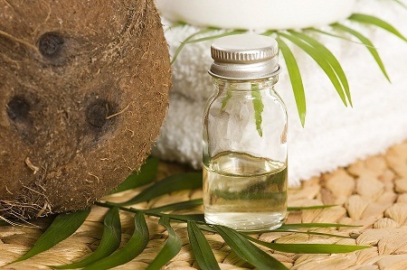 Picture of coconut oil with coconut and towel