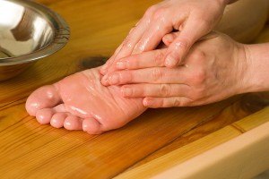 Photo of massaging coconut oil into one's foot