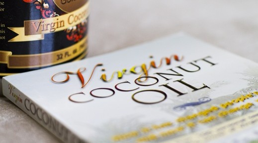 picture of coconut oil research book with jar of coconut oil