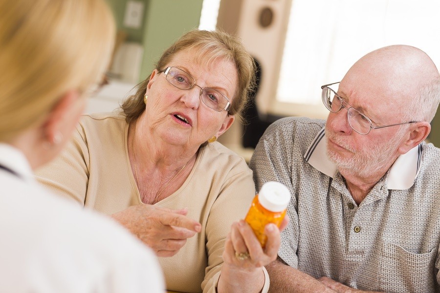Doctor or Nurse Explaining Prescription Medicine to Attentive Se